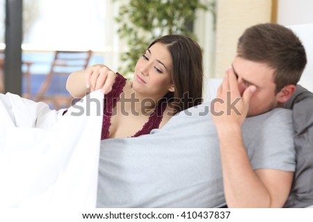 Man with erectile dysfunction during sex with her partner looking disappointed