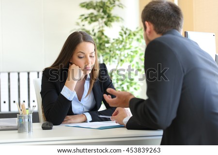 Bad salesman trying to convince to a bored client in her office or businessman in a job interview