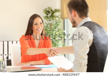 Happy employee and boss handshaking after a successful job interview at office