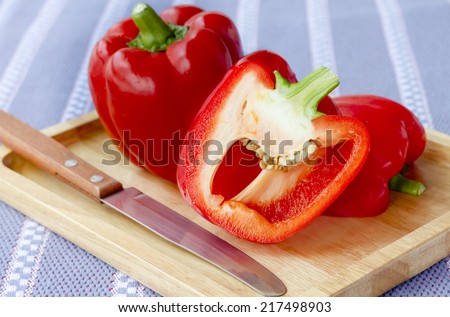 Two Red Pepper Sliced, Sweet red pepper on Wood Tray and Knife