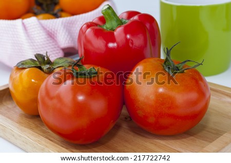 Ripe red tomato, Persimmon and Red Sweet Pepper, Fresh Twin Tomatoes on Tray