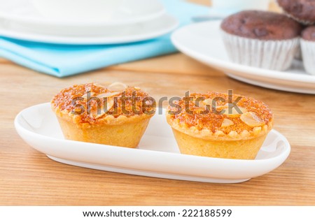 Almond Cake, Almond with Banana Cake Sweet and Snack for tea time, Fresh Almond Bakery Cake, Banana Cake Topped with Almonds or Almond banana bread on white plate wooden table.