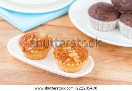 Almond Cakes, Almond with Banana Cake, Fresh Almond Bakery Cake, Banana Cake Topped with Almonds or Almond banana bread on white plate wooden table, Sweet and Snack for tea time
