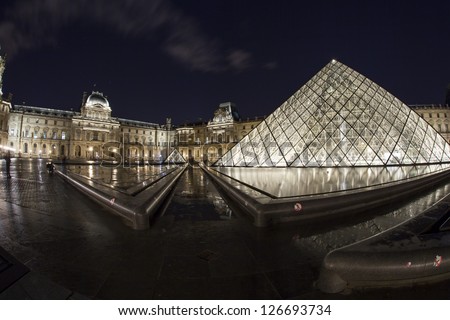 PARIS - JANUARY 01: The Louvre Pyramid and Museum at night, on January 01, 2013 in Paris, France. The pyramid serves as the main entrance to the Louvre Museum.