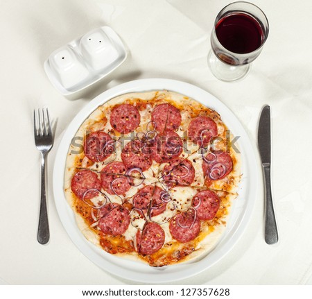 pizza pepperoni with fork and knife and red wine