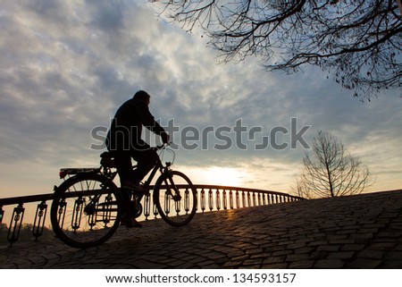 Silhouette of a man on muontain bike, sunrise