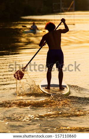 Silhouette Of Man Paddleboarding At Sunset, Florence River, Italy, Recreation Sport Paddling Ocean Beach Surf