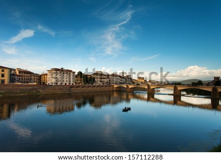 Florence across the Arno River. In the river by canoe canoeing.