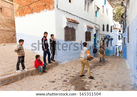 CHEFCHAOUEN, MOROCCO, NOVEMBER 20: kids playing on street of the Blue city of Chefchaouen, City is situated in the Rif Mountains in the North of Morocco, 2013