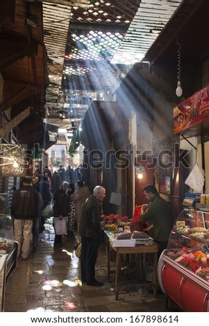 FES - NOVEMBER 24: Arabic people at covered market (souk) in a city Fes in Morocco. Fes is a historic city listed in UNESCO. NOVEMBER 24, 2013 Fes, Morocco.
