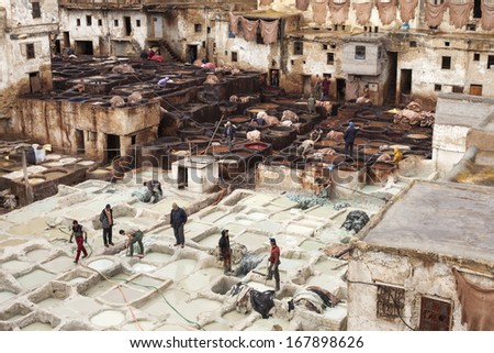 FES -  NOVEMBER 23: People working in the famous tannery complex of Fes in foul smelling conditions. All natural ancient process. Taken from the Terraces of Fes. November 23, 2013 Fes, Morocco