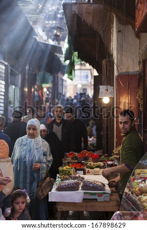 FES - NOVEMBER 24: Arabic people at covered market (souk) in a city Fes in Morocco. Fes is a historic city listed in UNESCO. NOVEMBER 24, 2013 Fes, Morocco.