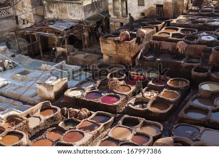 FES, MOROCCO - NOVEMBER 24: Workers at leather factory perform the work on November 24, 2013. Tanning production is one of the most ancient in Morocco
