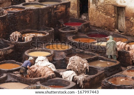 FES, MOROCCO - NOVEMBER 23: Workers at leather factory perform the work on November 23, 2013. Tanning production is one of the most ancient in Morocco
