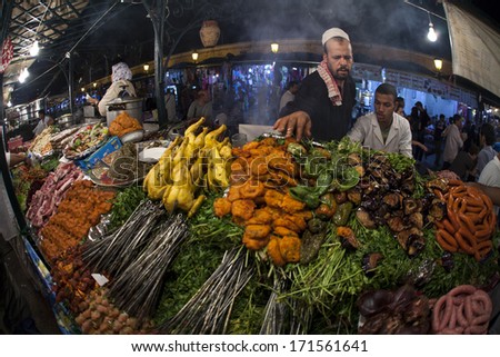 MARRAKESH ,MOROCCO - OCTOBER 8: Unidentified people selling food at night at the Djemaa el Fna square in Marrakesh on October 8, 2013 in Morocco. Every night the square turns into open air restaurant.