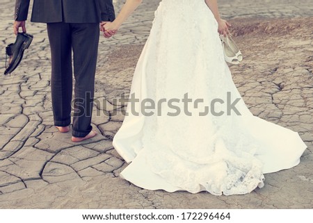 Wedding couple holding on trash the dress with dirty dress