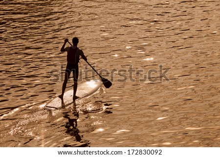 Silhouette Of Man Paddleboarding At Sunset, Florence River, Italy, Recreation Sport Paddling Ocean Beach Surf