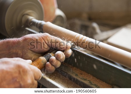 Worker working on wood with no safety equipment