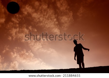 Silhouette of soccer man playing with the ball