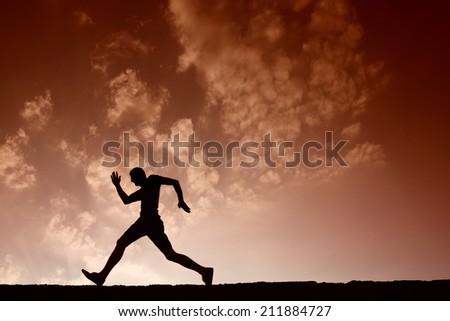 Silhouette of sport man running with blue sky and clouds on background