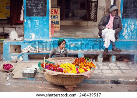 PUSHKAR, INDIA - JAN 08: Indian child selling flowers on street of Pushkar on January 08, 2015. Agra is a town in the Ajmer district in the Indian state of Rajasthan.