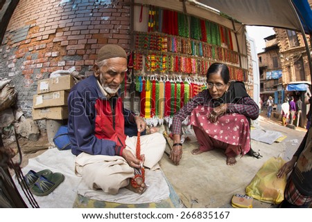 BHAKTAPUR, NEPAL - NOVEMBER 20: People working and selling goods in Bhaktapur on November 20, 2014 in Bhaktapur, Nepal