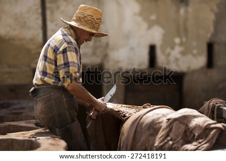 FEZ, MOROCCO - APRIL 19: Workers at leather factory perform the work on April 19, 2015. Tanning production is one of the most ancient in Morocco