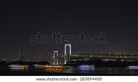 House boats in Tokyo bay and rainbow bridge at night