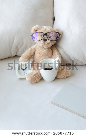 Doll bear and the clock with coffee cup on the Sofa soft  Concetp Time of relaxation for coffee brake