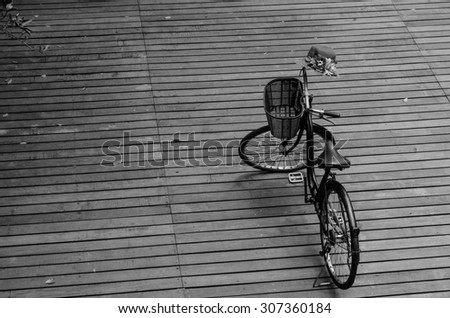 bicycle on the wooden floor black and white filter