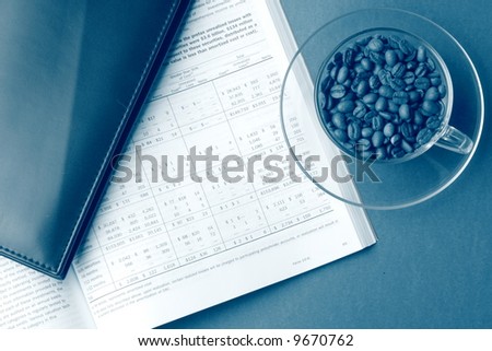 Business still life with report, cardholder, cup of coffee beans, toned