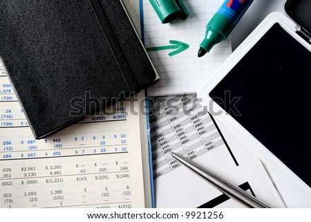 Daily financial reports, pen and notepad