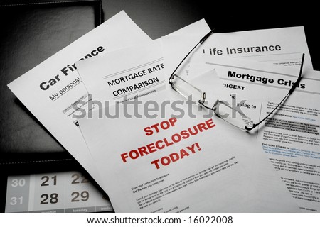 mortgage news papers and eye glasses on the table
