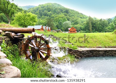 Stream with wooden water wheel in the Carpathians