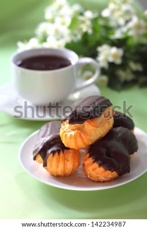 Eclairs with cream in chocolate coating