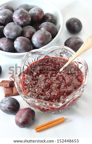 Plum jam with chocolate and cinnamon in a crystal bowl