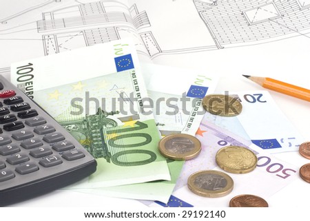Money and calculator on a blueprint