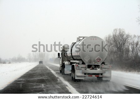 large semi-truck on highway, on a stormy winter day