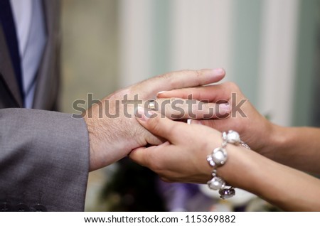 The bride groom wears a wedding ring