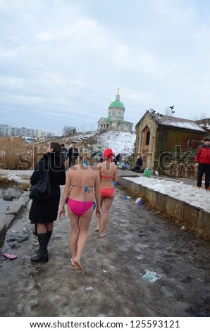 ROSTOV-ON-DON, RUSSIA - JAN 19: Women in bathing suits go swimming in the baptismal font - The celebration of Epiphany (Holy Baptism) in the Orthodox tradition, Jan 19, 2013 in Rostov-on-Don, Russia.