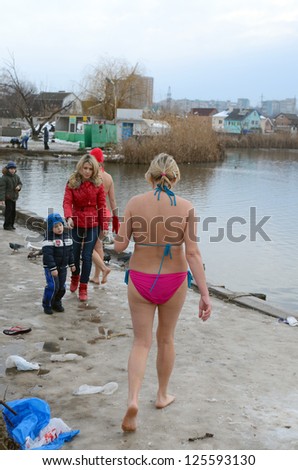 ROSTOV-ON-DON, RUSSIA - JAN 19: Women in bathing suits go swimming in the baptismal font - The celebration of Epiphany (Holy Baptism) in the Orthodox tradition, Jan 19, 2013 in Rostov-on-Don, Russia.