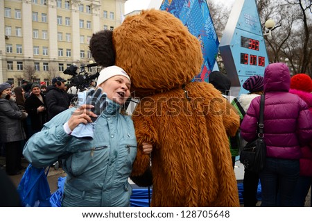 ROSTOV-ON-DON, RUSSIA - FEBRUARY 7: Woman dancing with Olympic Mishka - start Olympic countdown clock time before the Olympic Winter Games 2014 in Sochi, February 7, 2013 in Rostov-on-Don, Russia
