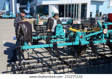 ROSTOV-ON-DON, RUSSIA - FEBRUARY 27: Men around Harrow - An exhibit at the exhibition of agricultural equipment Agrotechnologies-2013, February 27, 2013 in Rostov-on-Don, Russia