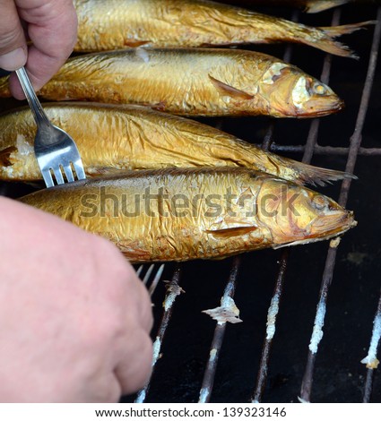 Don Herring golden brown on the gridiron - hot smoked fish, cooked in a smokehouse in the field