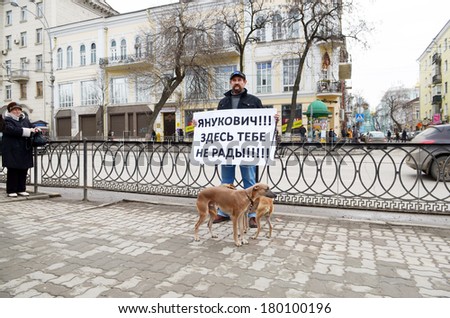 ROSTOV-ON-DON, RUSSIA - MARCH 2: Yanukovych! Here you are not welcome!! Picket in the city center, a man with a placard and Italian greyhound, March 2, 2014 in Rostov-on-Don, Russia
