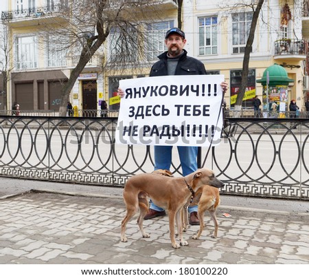 ROSTOV-ON-DON, RUSSIA - MARCH 2: Yanukovych! Here you are not welcome!! Picket in the city center, a man with a placard and Italian greyhound, March 2, 2014 in Rostov-on-Don, Russia