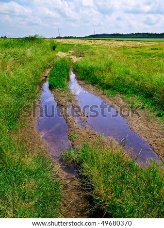 agriculture field dirty road with blue pools