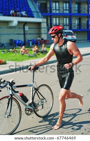 The young sportsman going  a bicycle stage  on a thriathlon competitions