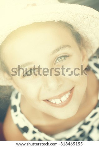 Portrait of beautiful smiling little girl with green eyes