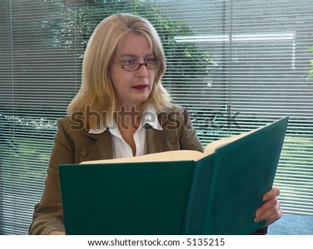 Surprised woman reading book.